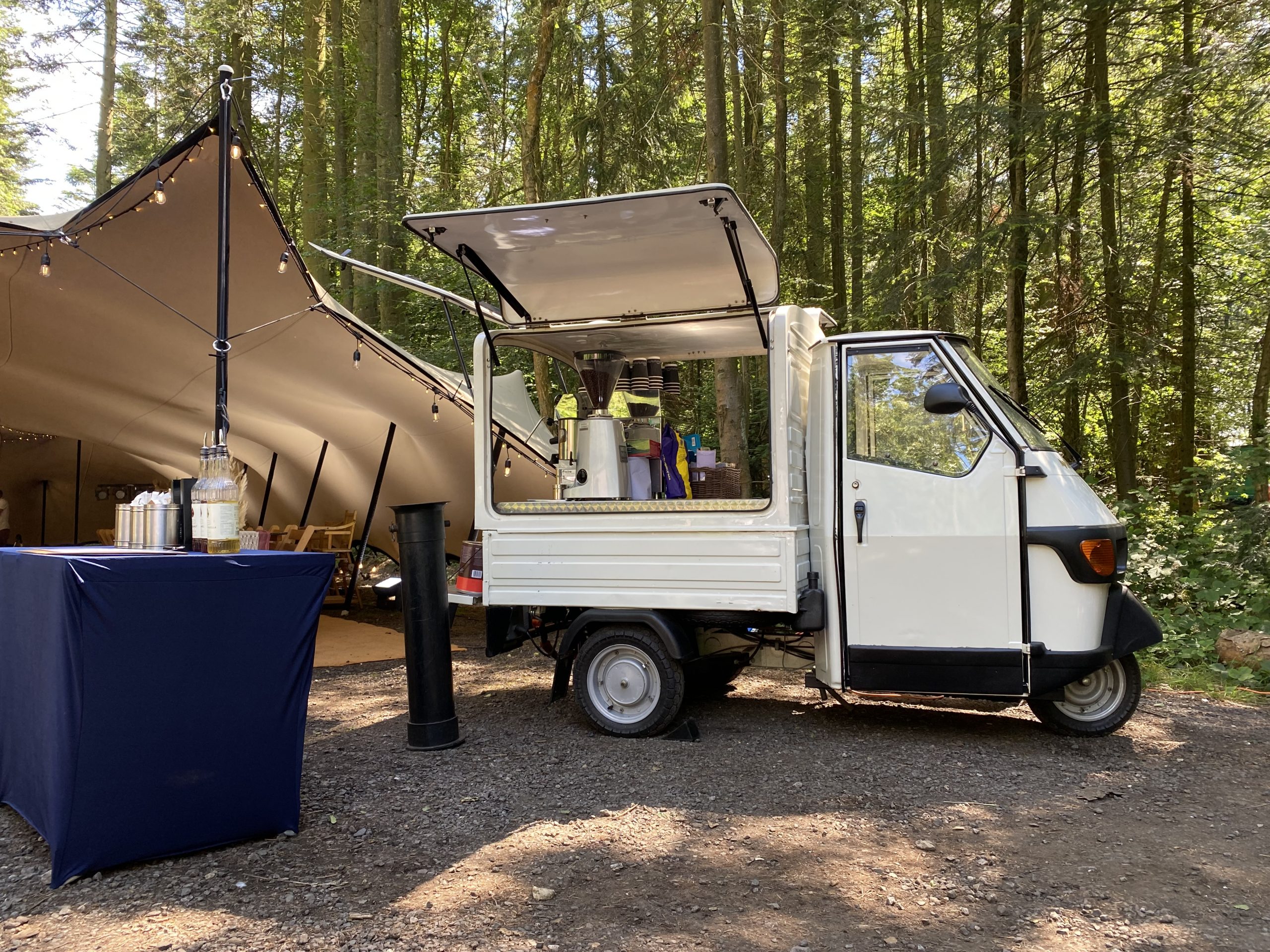 The Mobile Coffee Bean Piaggio Ape van at an outdoor event