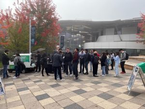 Branded mobile coffee van with barista service attracts customers